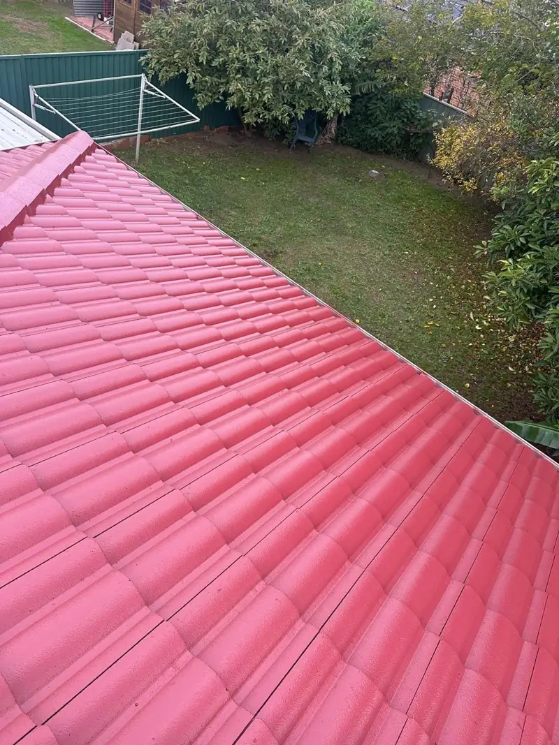 Restored red tile roof running down to the gutter line