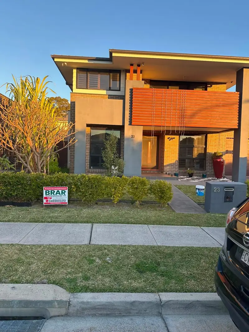 Two-storey home with a Brar Roofing sign out the front